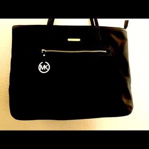 Michael Kors canvas bag with gold zipper and gold emblems